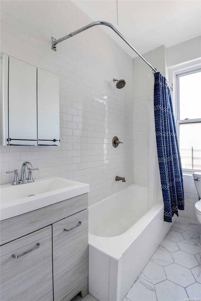 full bathroom with vanity, decorative backsplash, toilet, shower / bath combo with shower curtain, and tile walls