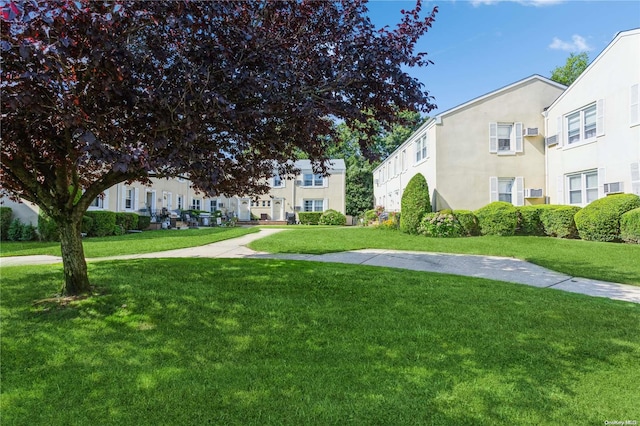 view of home's community with a yard