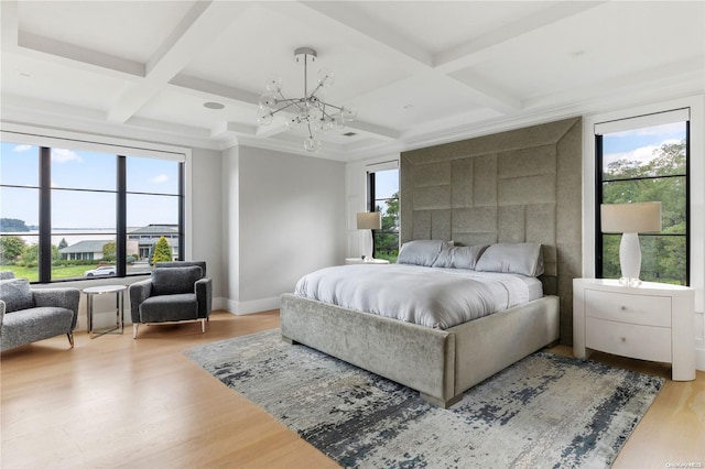 bedroom with beamed ceiling, multiple windows, and coffered ceiling