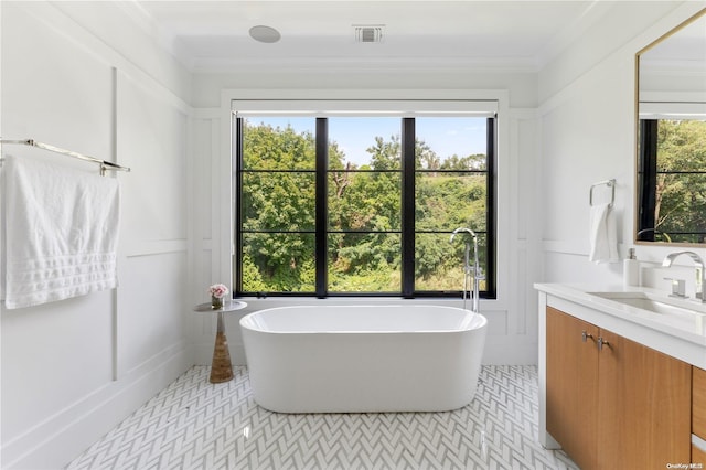 bathroom featuring crown molding, a wealth of natural light, and a tub