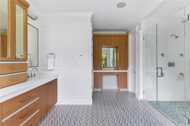 bathroom with vanity, an enclosed shower, and crown molding