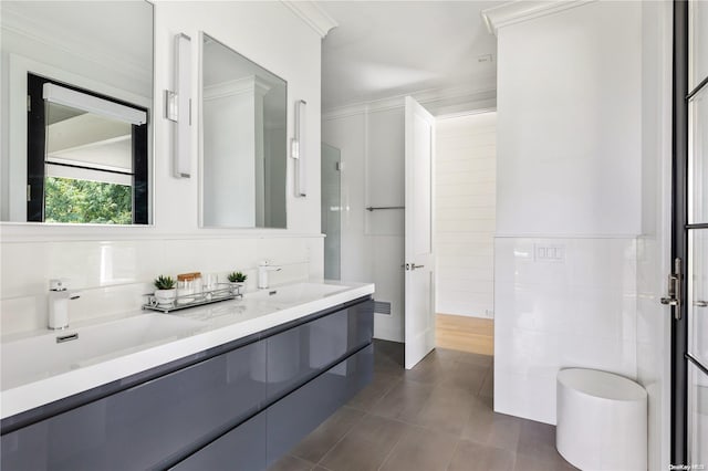 bathroom with vanity, crown molding, and tile walls