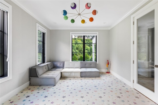 living room with a chandelier and crown molding