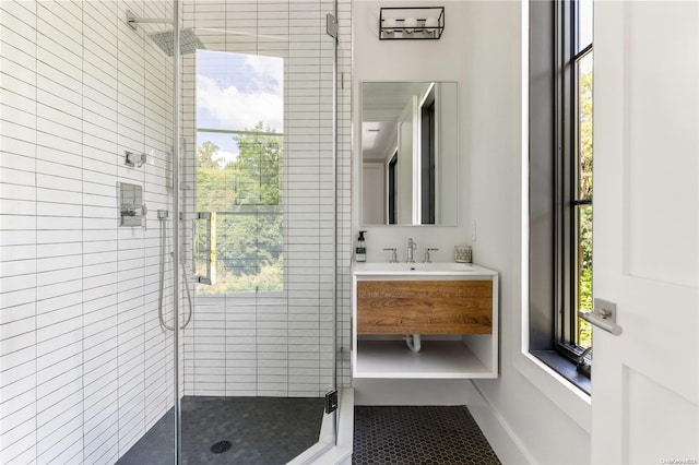 bathroom with vanity and a shower with door