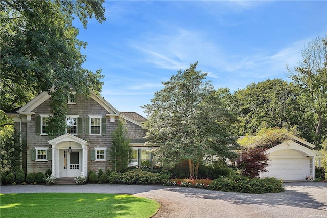 view of front facade with a garage and a front lawn