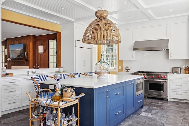 kitchen featuring blue cabinetry, beam ceiling, luxury stove, extractor fan, and white cabinets