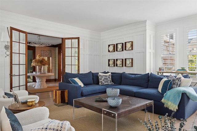 living room with wood-type flooring, crown molding, and french doors