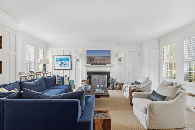 living room with wood-type flooring and ornamental molding