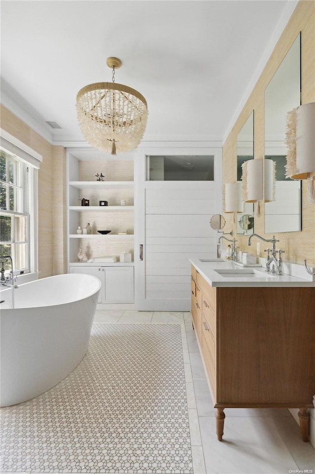 bathroom featuring a tub to relax in, tile patterned floors, vanity, and a chandelier