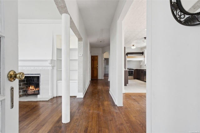 hall featuring dark hardwood / wood-style floors and ornamental molding