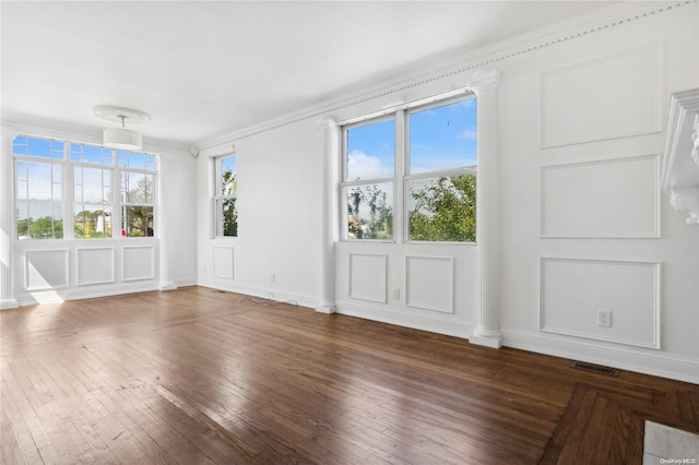 interior space featuring plenty of natural light, dark hardwood / wood-style flooring, and ornamental molding