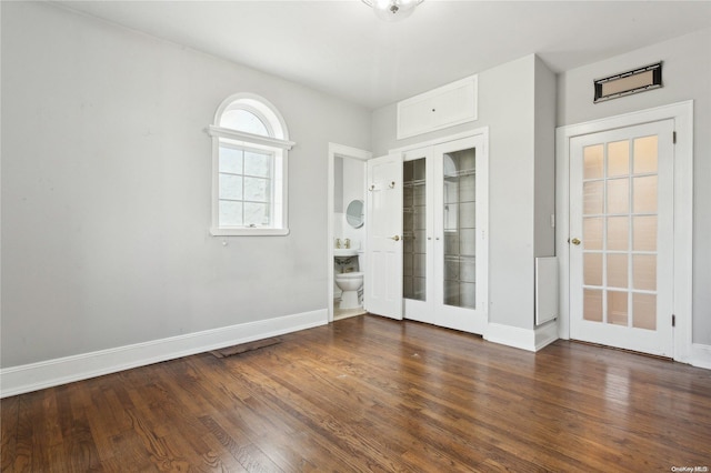 unfurnished room with dark wood-type flooring