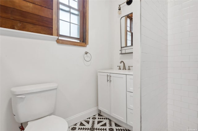 bathroom featuring tile patterned flooring, vanity, and toilet