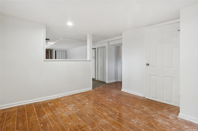 unfurnished room with wood-type flooring