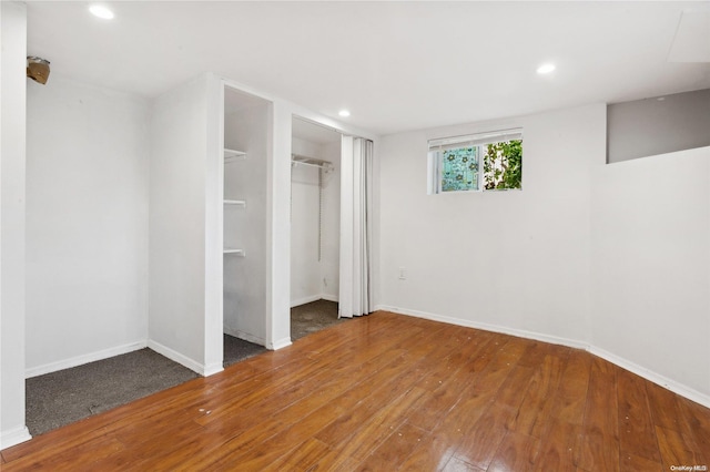 unfurnished bedroom featuring a closet and hardwood / wood-style floors