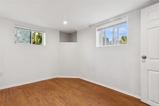 spare room featuring hardwood / wood-style floors and a healthy amount of sunlight