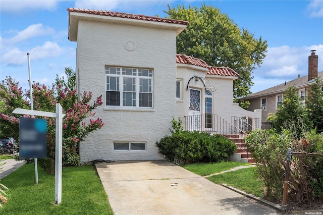 mediterranean / spanish-style home featuring a front lawn