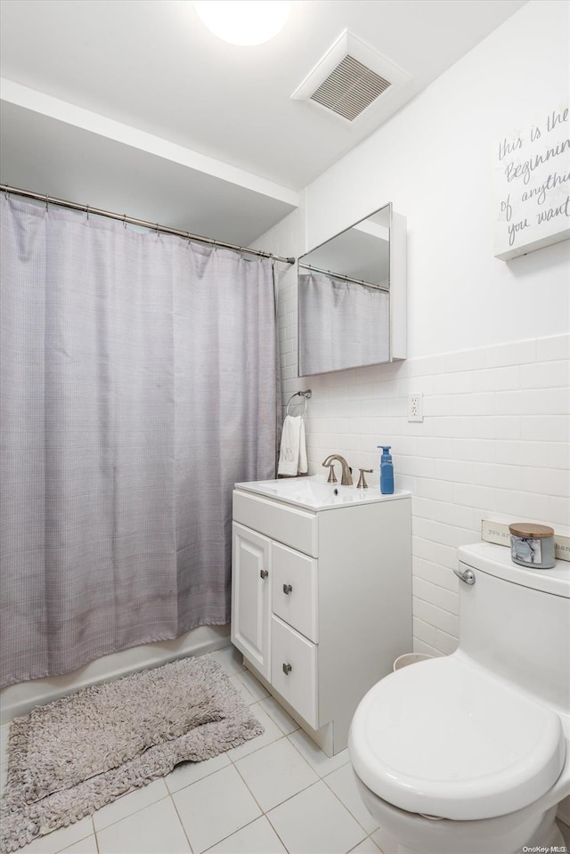 525 Bch 138th St Unit A2, Belle Harbor, NY 11694 - bathroom with vanity, toilet, tile patterned floors, and tile walls