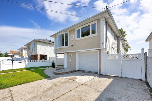 view of front of house with a front yard and a garage