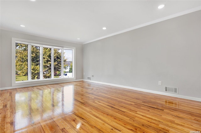 spare room with light hardwood / wood-style floors and ornamental molding