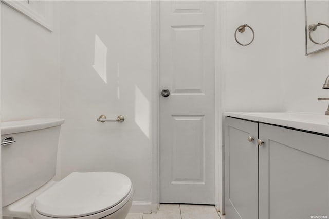 bathroom with tile patterned flooring, vanity, and toilet