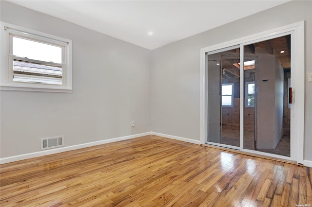 empty room featuring light hardwood / wood-style floors and a healthy amount of sunlight