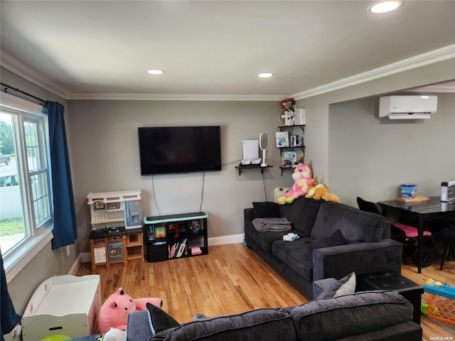 living room with wood-type flooring, ornamental molding, and a wall unit AC