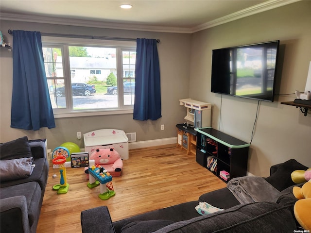 rec room with wood-type flooring and crown molding