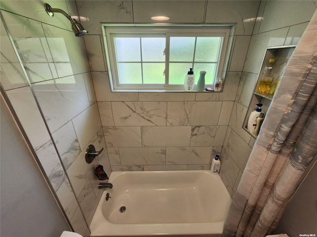 bathroom with shower / bath combo with shower curtain