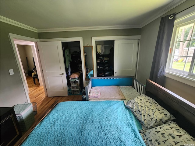 bedroom with wood-type flooring and crown molding