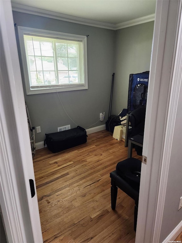 miscellaneous room with crown molding and hardwood / wood-style flooring