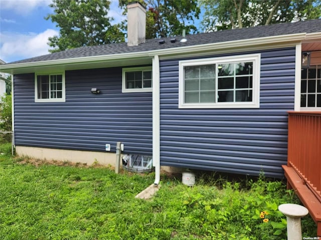 view of side of property with a lawn