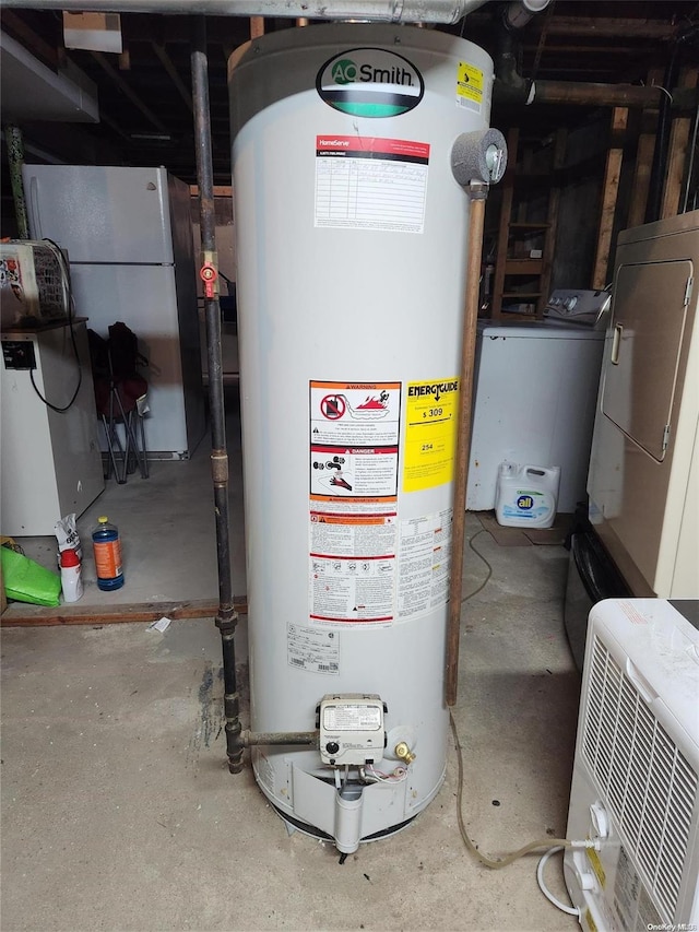 utility room featuring washer / dryer and water heater