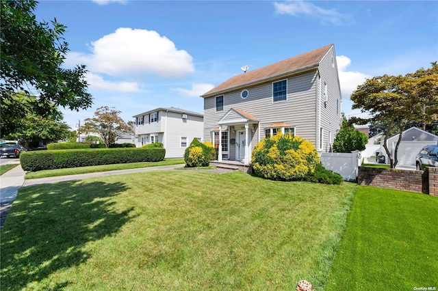 colonial inspired home with a front lawn