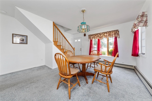 carpeted dining space with a notable chandelier and baseboard heating