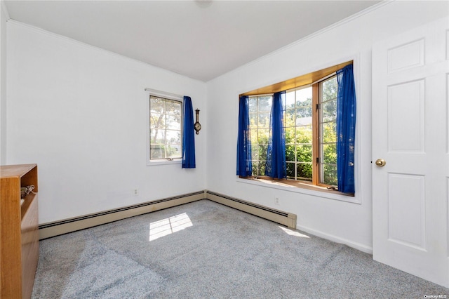 carpeted empty room with a baseboard heating unit and ornamental molding