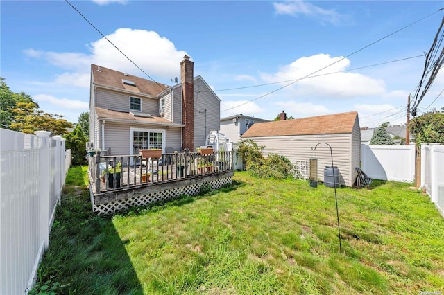 rear view of property featuring a deck and a yard