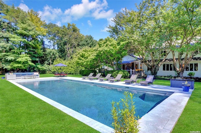 pool featuring a patio area, an outdoor hangout area, and a yard