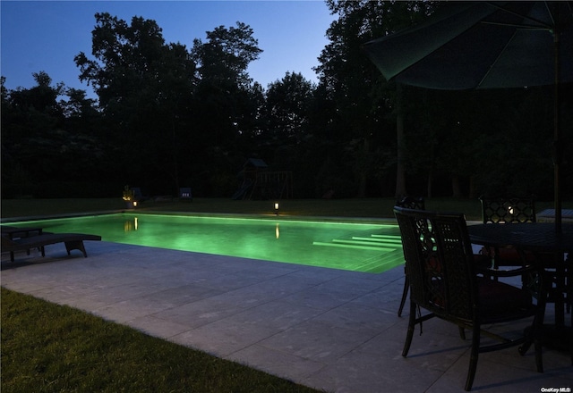 outdoor pool featuring a patio and a yard