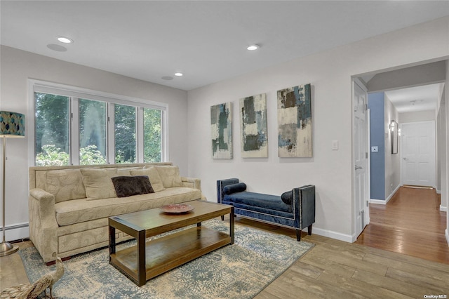 living area with baseboards, baseboard heating, wood finished floors, and recessed lighting