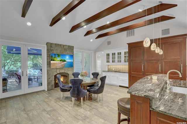 dining room with light wood-type flooring, visible vents, and french doors