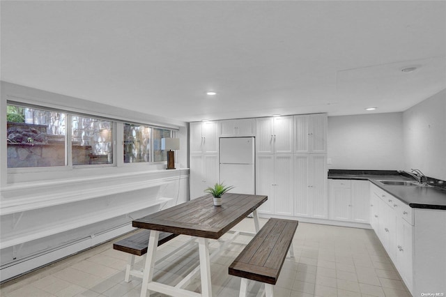 dining room featuring baseboard heating and recessed lighting