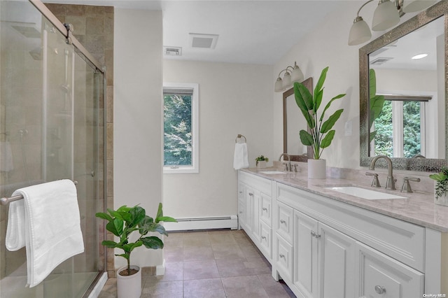 full bath with a stall shower, a baseboard radiator, visible vents, and a sink