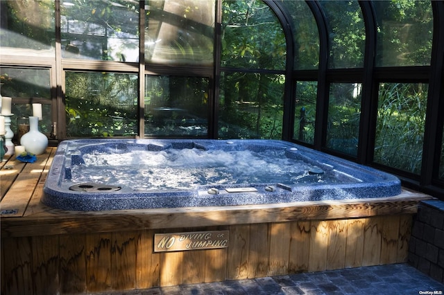 unfurnished sunroom featuring a hot tub