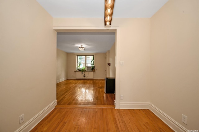 corridor with hardwood / wood-style flooring