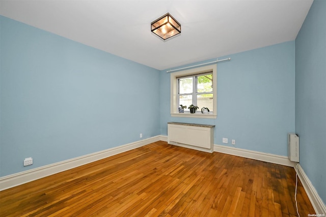 unfurnished room featuring hardwood / wood-style floors