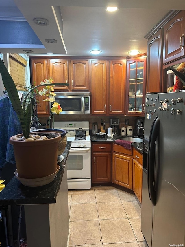 kitchen featuring light tile patterned flooring, sink, and appliances with stainless steel finishes