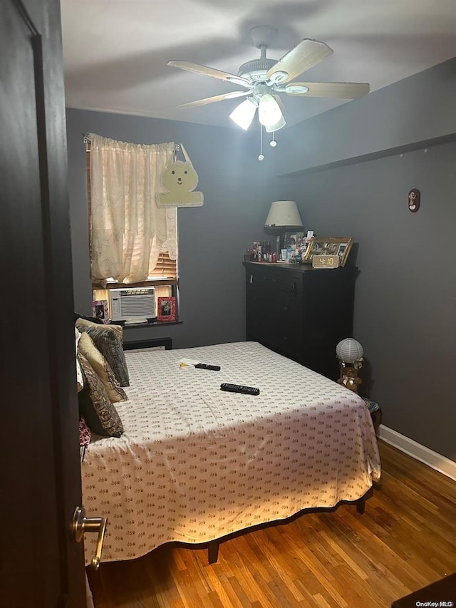 bedroom with ceiling fan, hardwood / wood-style floors, and cooling unit