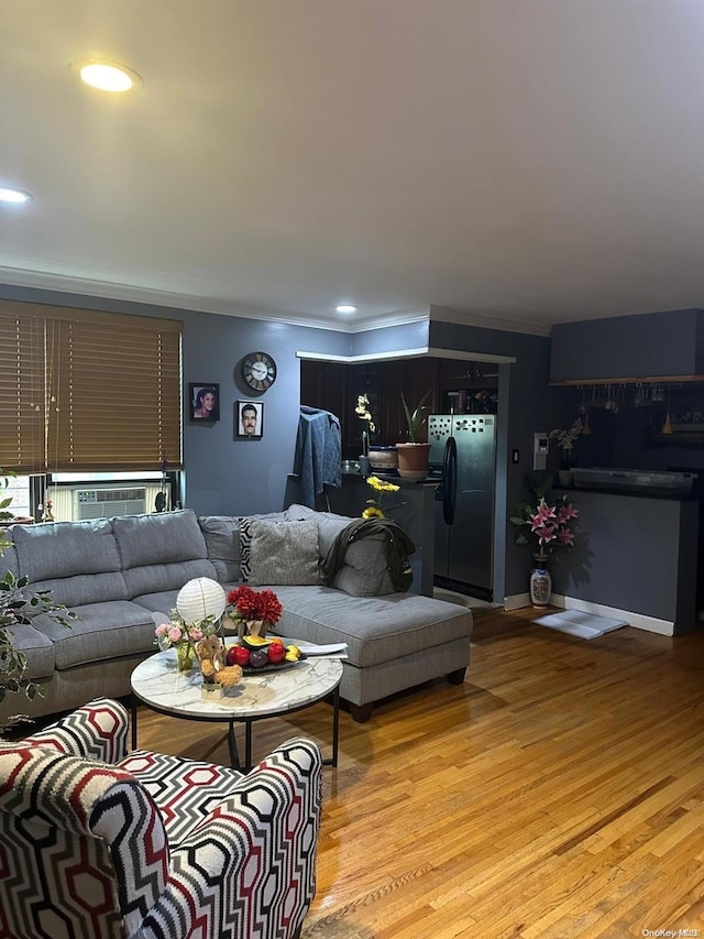 living room featuring crown molding and light hardwood / wood-style floors