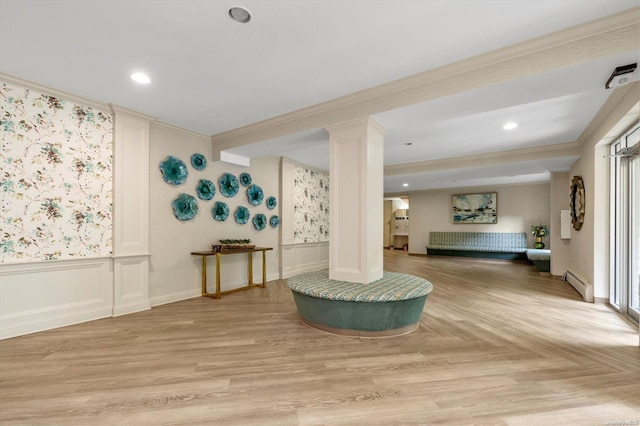 interior space with crown molding, a baseboard radiator, and light wood-type flooring